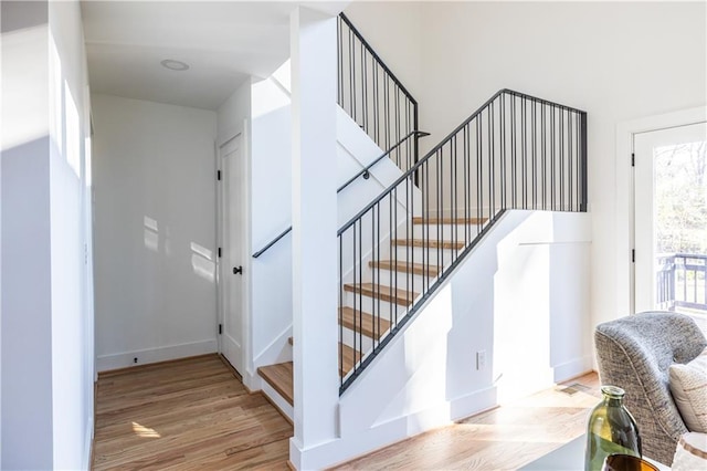 stairs with hardwood / wood-style flooring