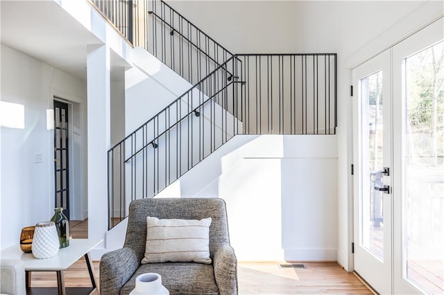 foyer with french doors and light hardwood / wood-style flooring