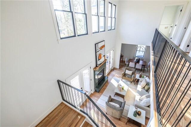 living room featuring a high ceiling and light hardwood / wood-style flooring