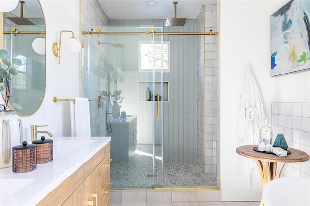 bathroom with tile patterned floors, vanity, and a shower with door