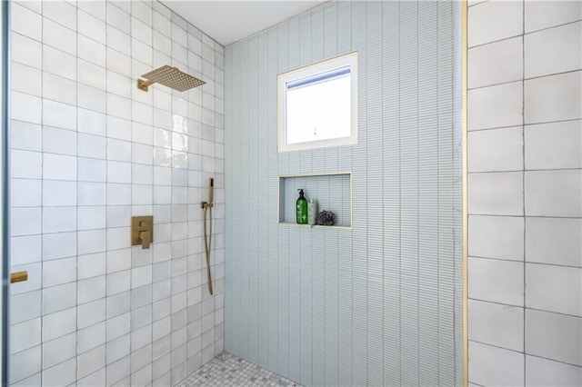 bathroom with a tile shower