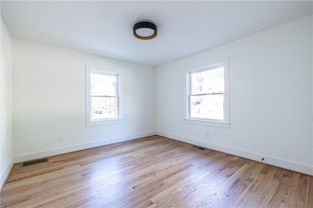 spare room with a healthy amount of sunlight and light wood-type flooring