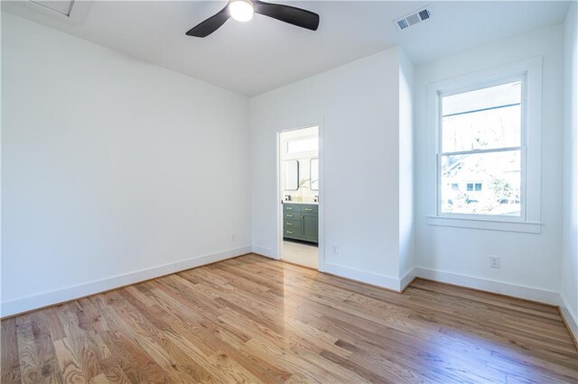 unfurnished bedroom with ceiling fan, light hardwood / wood-style flooring, and ensuite bath