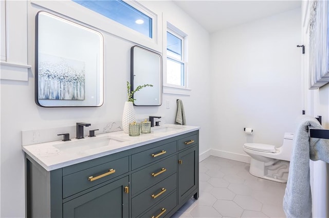 bathroom featuring tile patterned floors, vanity, and toilet