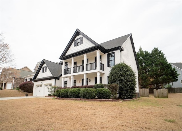 neoclassical / greek revival house with a balcony, concrete driveway, an attached garage, central AC, and a porch