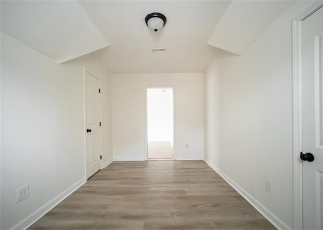 unfurnished room featuring wood finished floors and baseboards