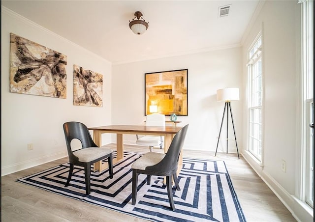 office area featuring wood finished floors, baseboards, and ornamental molding