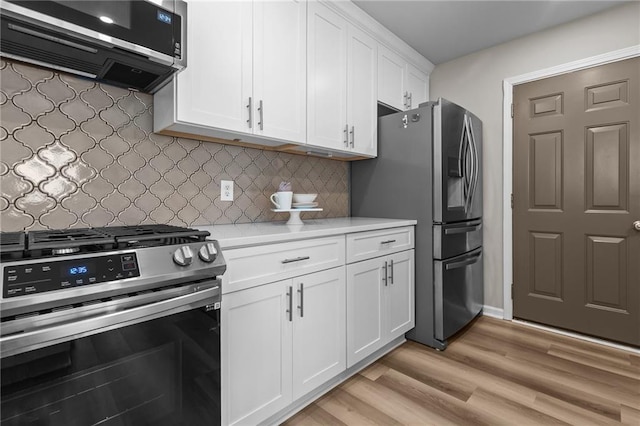 kitchen featuring stainless steel appliances, exhaust hood, light countertops, white cabinets, and light wood-type flooring