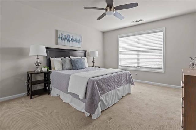 bedroom featuring light carpet, baseboards, and a ceiling fan