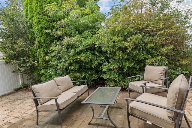 view of patio featuring an outdoor hangout area and fence