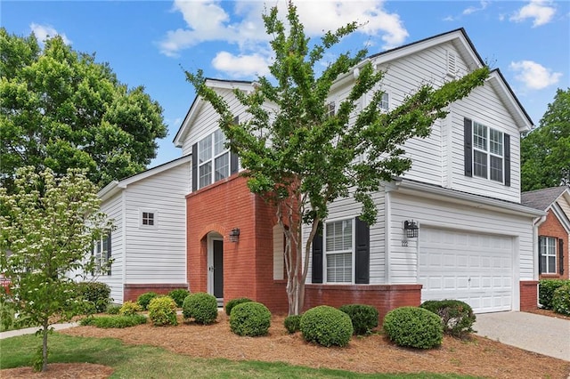 view of front of house with brick siding, a garage, and driveway
