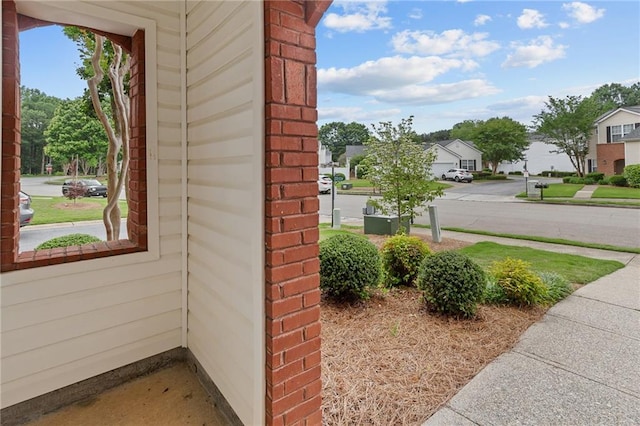 view of side of home with brick siding and a residential view