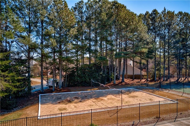 view of community featuring fence and volleyball court