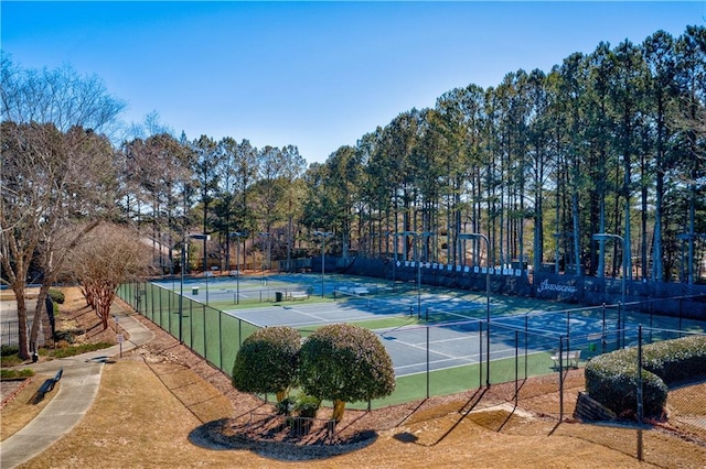 view of tennis court featuring fence