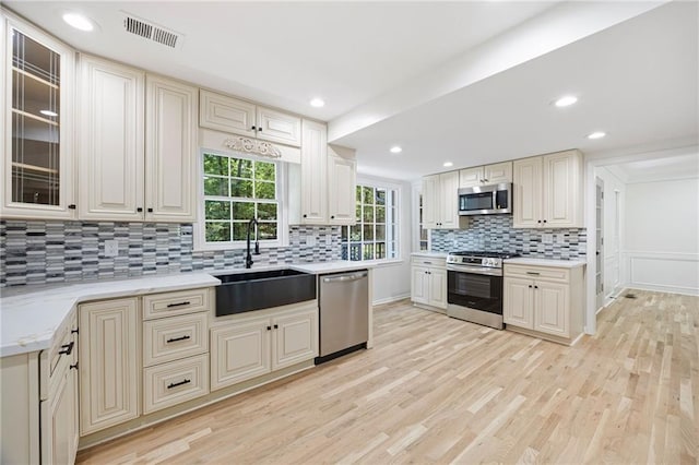 1172 Colony Dr, Marietta, GA 30068 - kitchen featuring stainless steel appliances, tasteful backsplash, light wood finished floors, glass insert cabinets, and recessed lighting