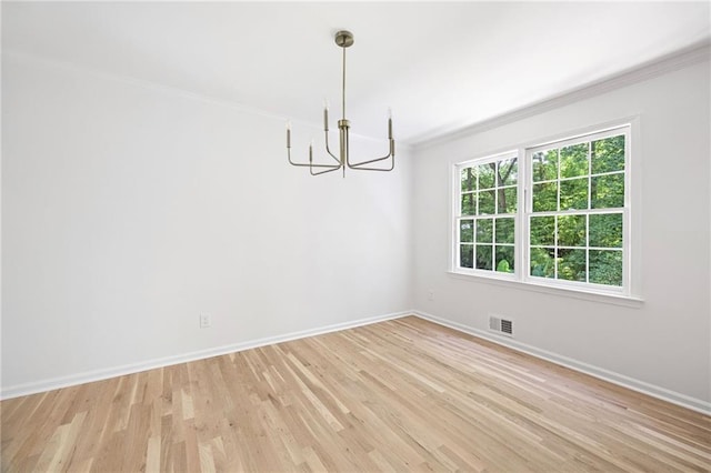 1172 Colony Dr, Marietta, GA 30068 - spare room featuring a chandelier, crown molding, and light wood finished floors