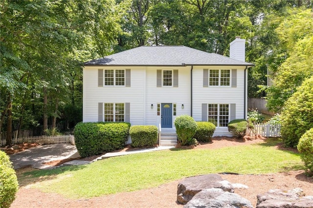 1172 Colony Dr, Marietta, GA 30068 - colonial inspired home featuring a chimney and view of wooded area