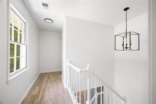 1172 Colony Dr, Marietta, GA 30068 - corridor featuring an upstairs landing, light wood-style flooring, and a chandelier