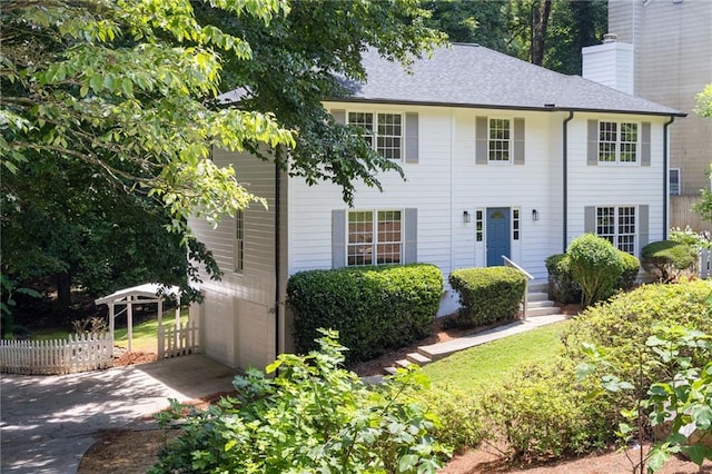 1172 Colony Dr, Marietta, GA 30068 - colonial inspired home featuring a chimney, driveway, and roof with shingles