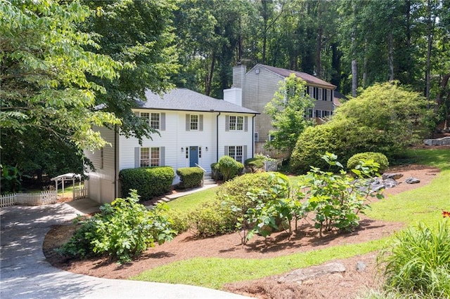 1172 Colony Dr, Marietta, GA 30068 - colonial-style house featuring a chimney, driveway, and a carport