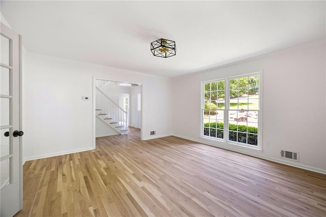 1172 Colony Dr, Marietta, GA 30068 - unfurnished room featuring light wood-style floors, stairway, and crown molding