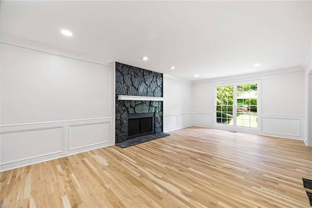 1172 Colony Dr, Marietta, GA 30068 - unfurnished living room with a decorative wall, crown molding, light wood-style floors, a fireplace, and recessed lighting