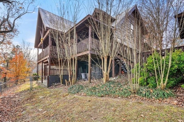 exterior space with a gate, fence, and a wooden deck