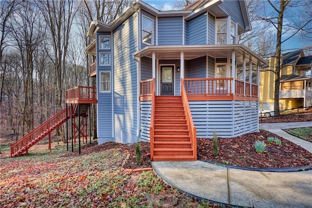 view of front of property with stairway and covered porch