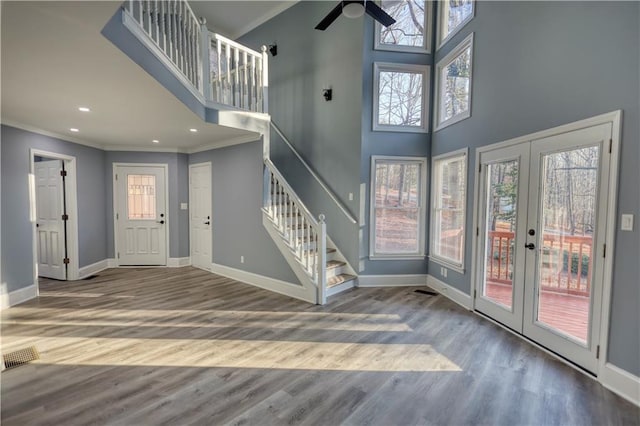 entryway with stairway, baseboards, and ornamental molding