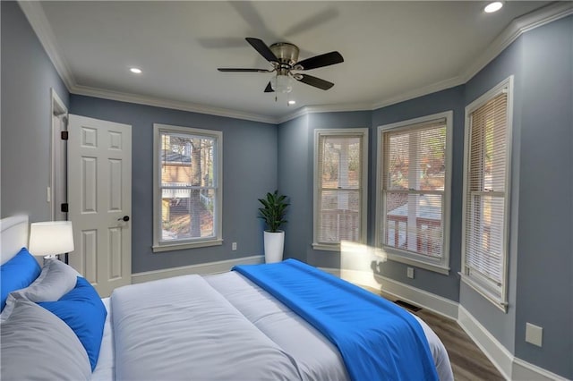 bedroom featuring visible vents, crown molding, baseboards, recessed lighting, and wood finished floors