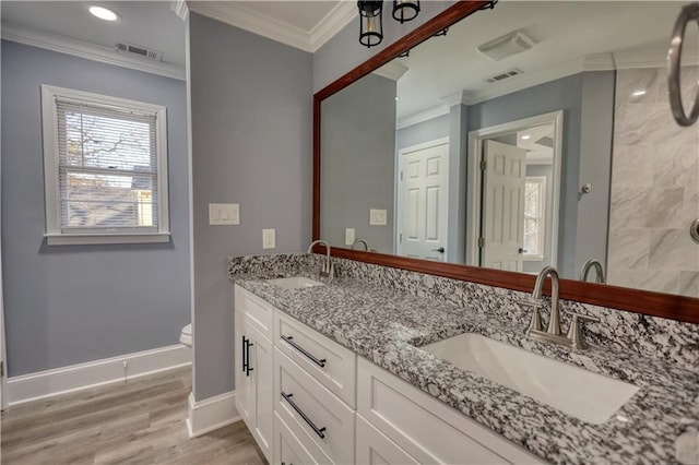 full bathroom with a sink, visible vents, and crown molding