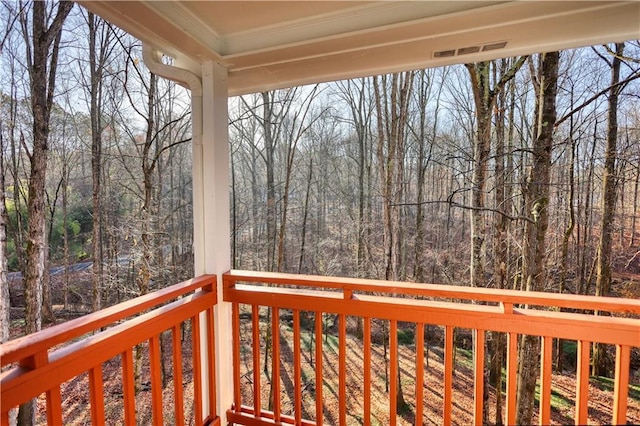 deck featuring a forest view and visible vents