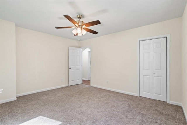 unfurnished bedroom featuring ceiling fan, a closet, baseboards, and carpet flooring