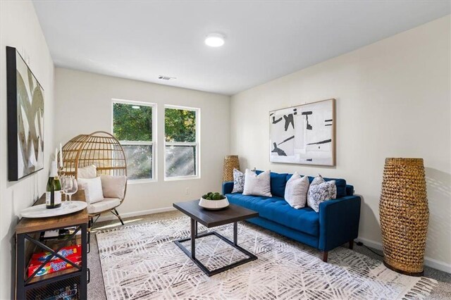 home office with carpet floors, visible vents, and baseboards