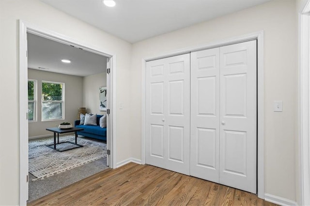 entryway featuring recessed lighting, wood finished floors, and baseboards