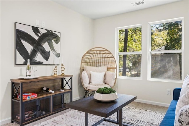 sitting room featuring carpet flooring, visible vents, and baseboards