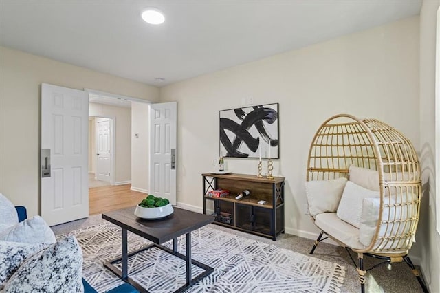 living area featuring baseboards