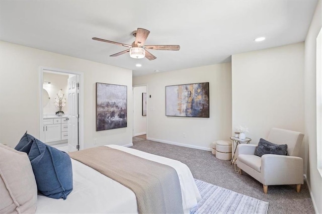 bedroom with recessed lighting, light carpet, a ceiling fan, baseboards, and ensuite bath