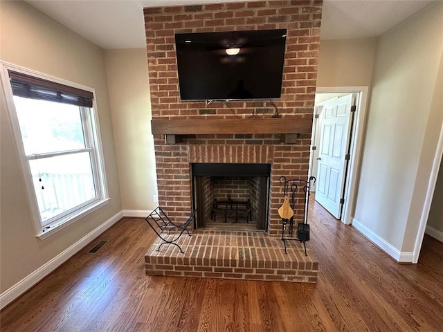 42 Powell Rd NW, Adairsville, GA 30103 - detailed view of baseboards, wood finished floors, and a brick fireplace
