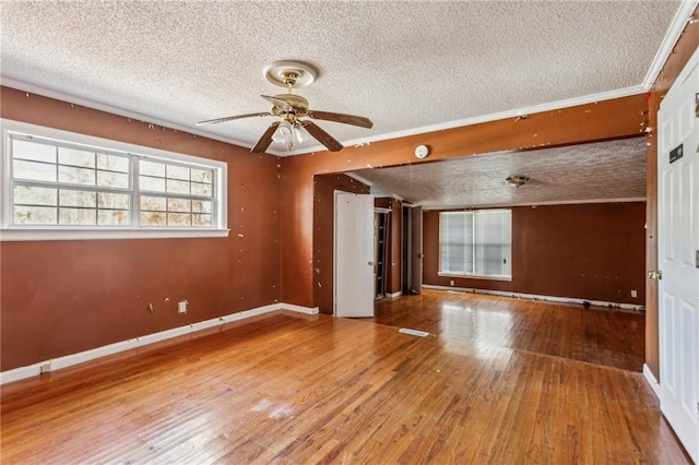 spare room featuring ceiling fan, hardwood / wood-style flooring, and a textured ceiling