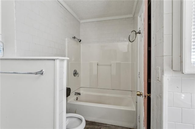 bathroom featuring crown molding, shower / tub combination, toilet, and a textured ceiling