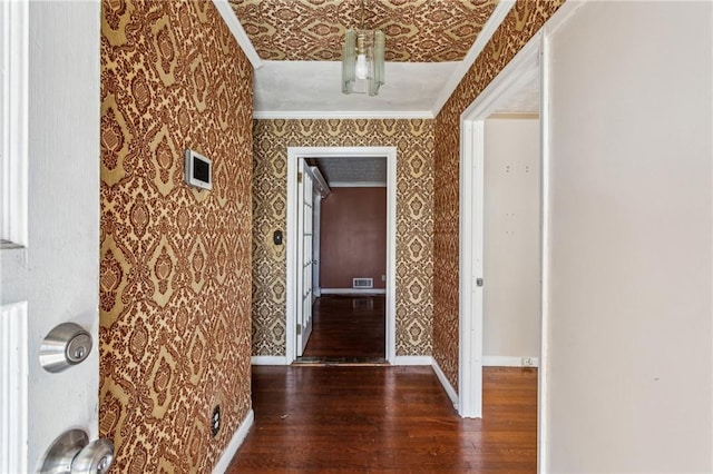 corridor featuring crown molding and dark hardwood / wood-style floors