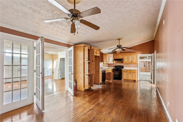 kitchen with lofted ceiling, wood-type flooring, black appliances, a textured ceiling, and french doors