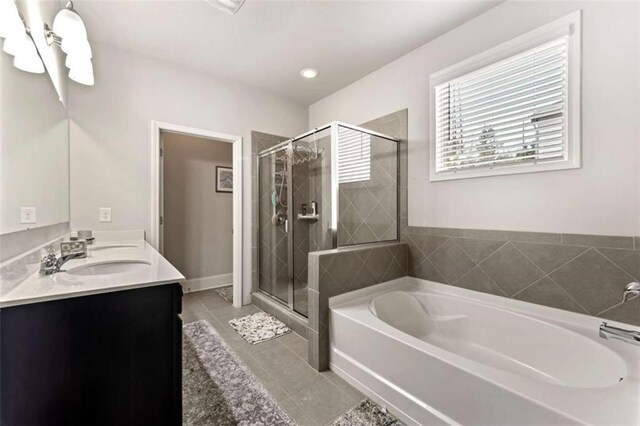 736 Red Wolf Run, Atlanta, GA 30349 - bathroom featuring tile patterned floors, a garden tub, a stall shower, a sink, and double vanity
