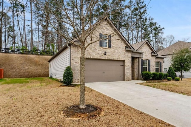 736 Red Wolf Run, Atlanta, GA 30349 - view of front of home featuring concrete driveway, a garage, and brick siding