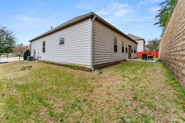736 Red Wolf Run, Atlanta, GA 30349 - view of property exterior featuring a yard, cooling unit, a patio, and fence