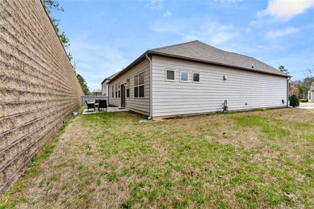 736 Red Wolf Run, Atlanta, GA 30349 - back of house featuring a patio and a lawn