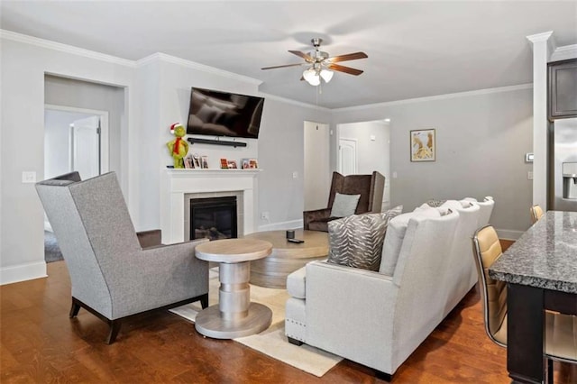 736 Red Wolf Run, Atlanta, GA 30349 - living room with ornamental molding, baseboards, a ceiling fan, and dark wood-style flooring