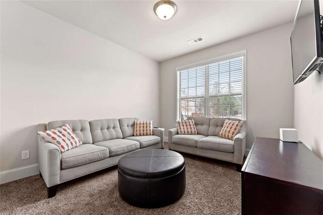 736 Red Wolf Run, Atlanta, GA 30349 - living room featuring visible vents, baseboards, and dark colored carpet