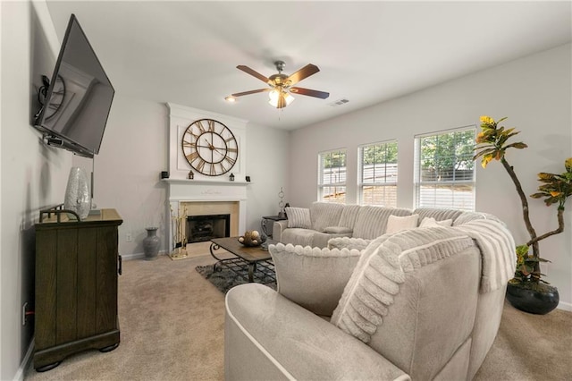 carpeted living room featuring ceiling fan